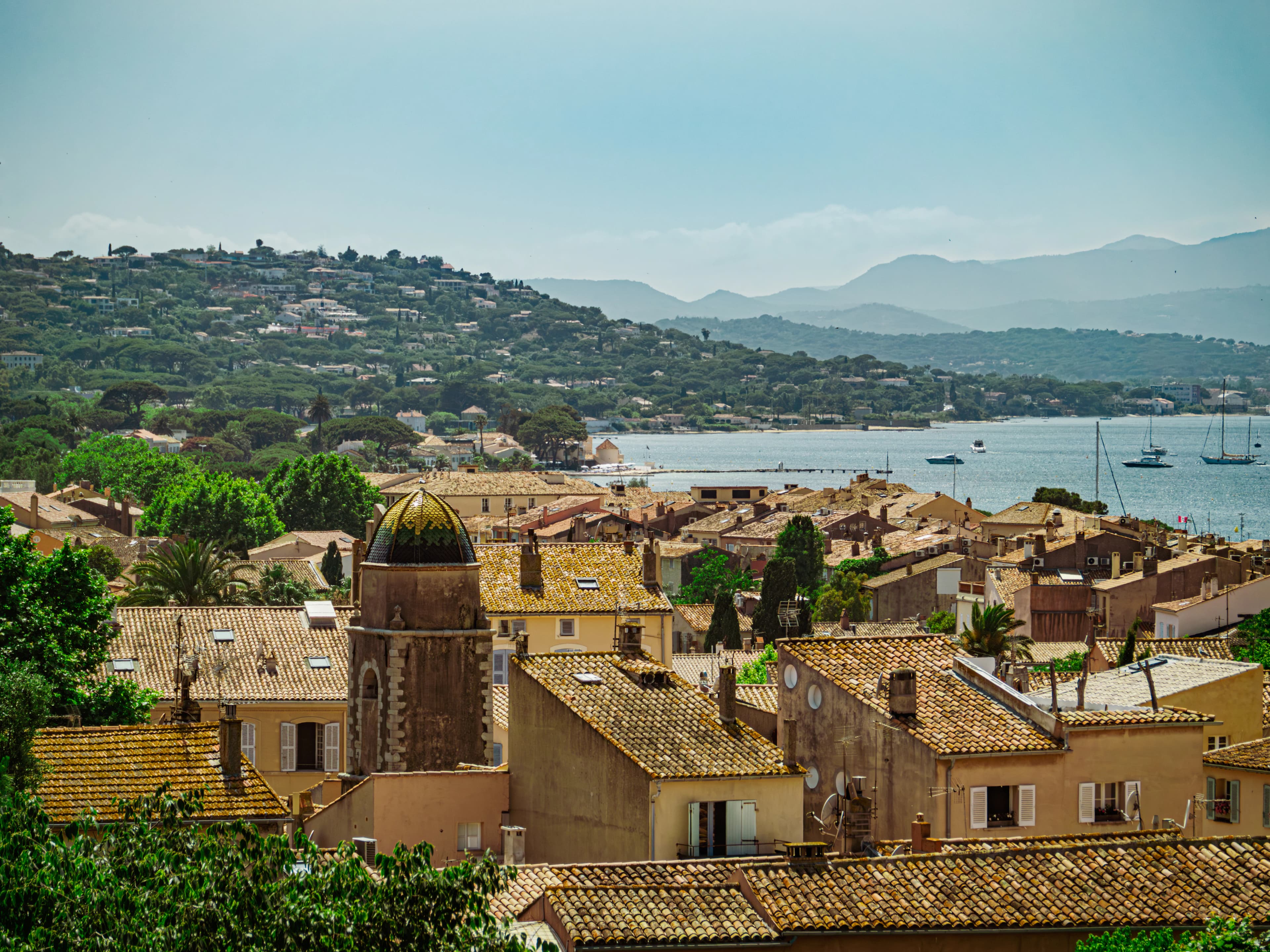 A coastal town with buildings and a bay.