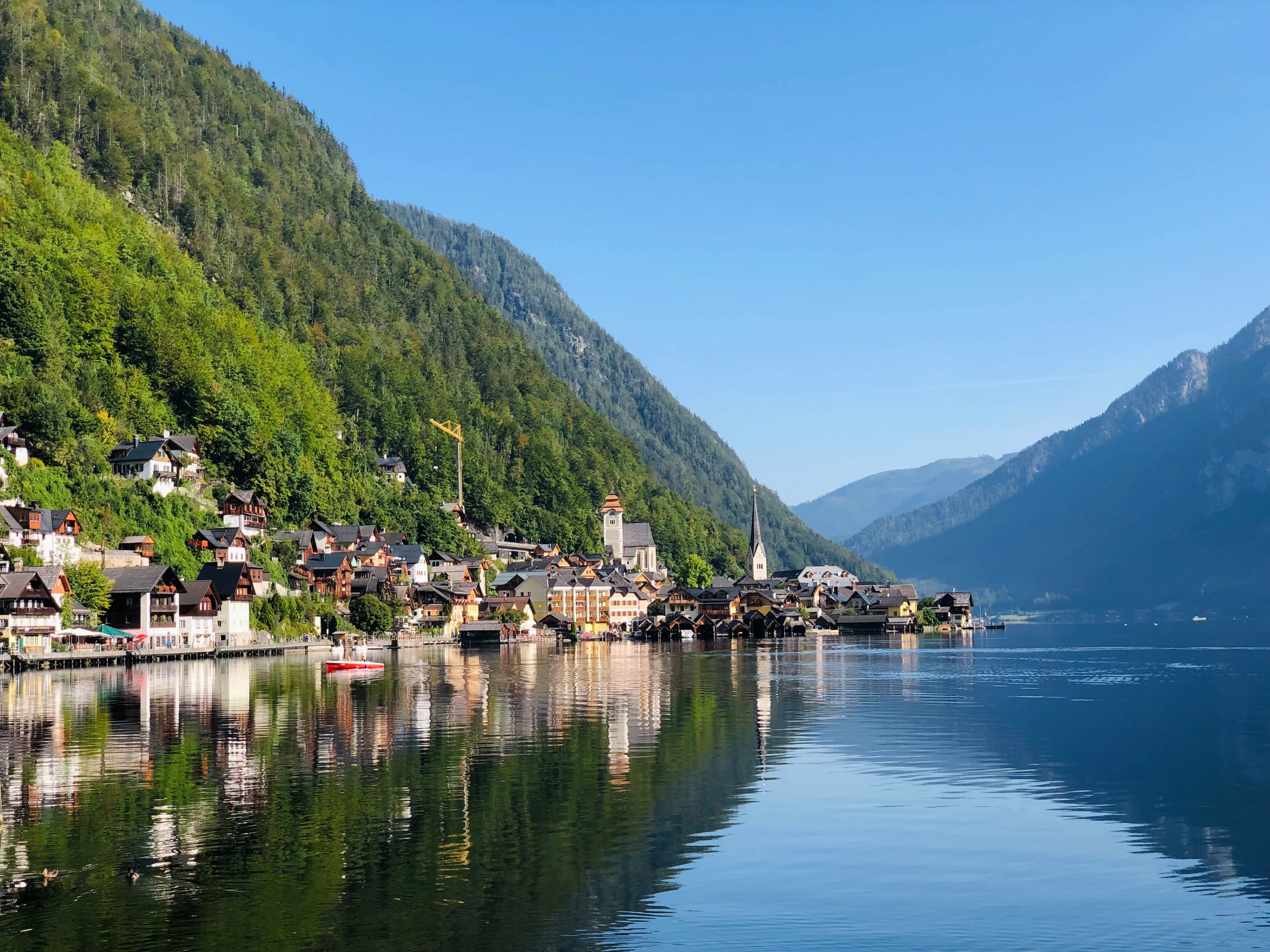 green mountain beside body of water during daytime